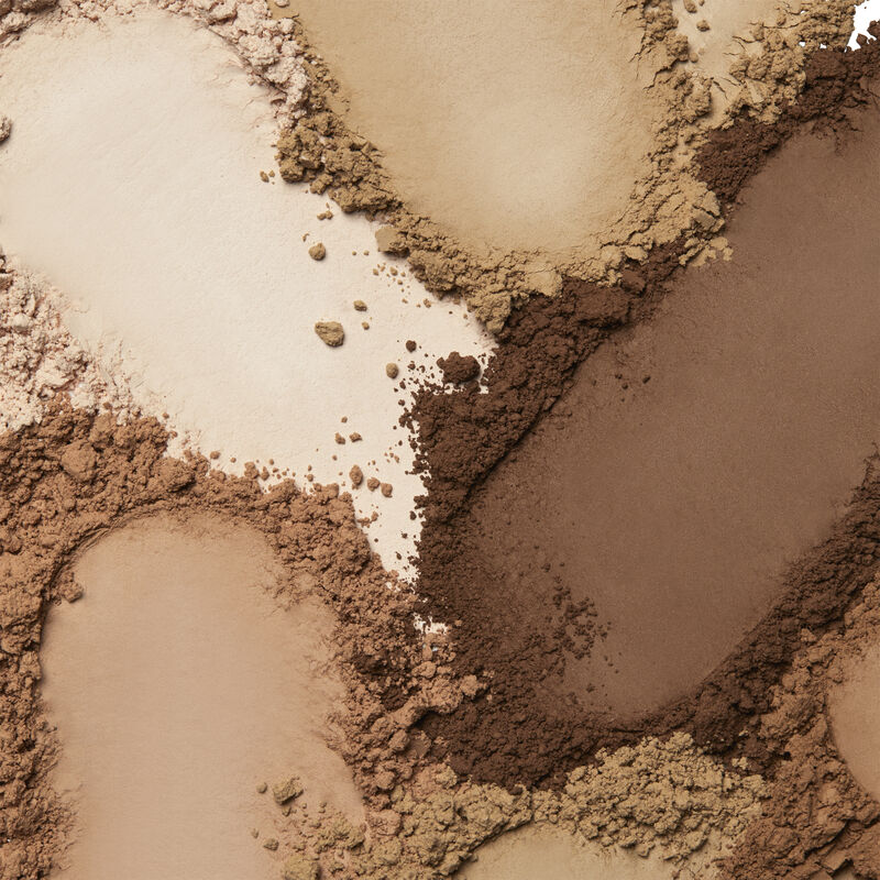Product rubs of Mary Kay Silky Setting Powder in shades ranging across ivory, beige and bronze. image number null