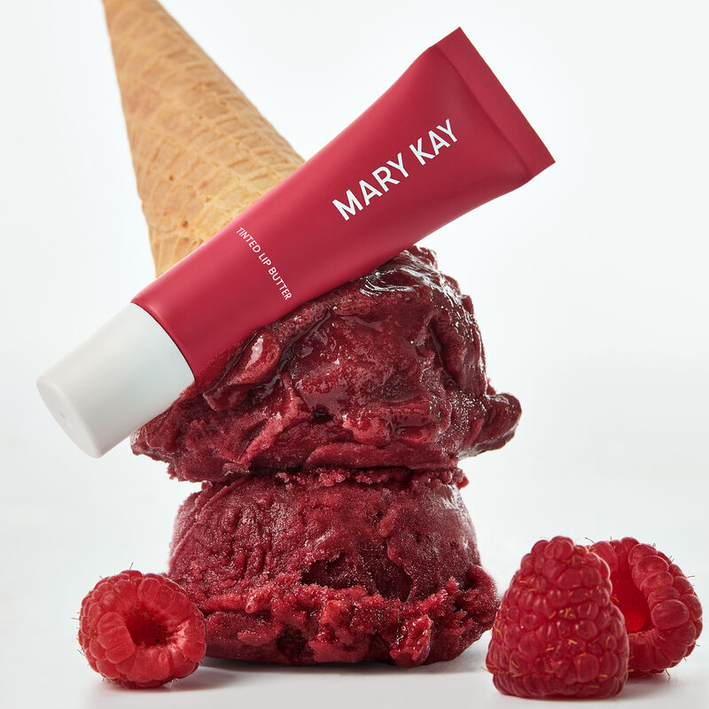 Tinted Lip Butter in Raspberry Sorbet styled atop raspberry sorbet scoops and ice cream cone
